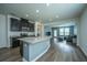 Open concept kitchen with a large island, stainless steel appliances, and dark cabinets at 1689 Eider Down Dr, Summerville, SC 29483