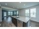 Spacious kitchen featuring a large island, stainless steel appliances, and ample natural light at 1689 Eider Down Dr, Summerville, SC 29483
