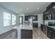Bright kitchen featuring dark cabinets, stainless steel appliances, and a center island at 1689 Eider Down Dr, Summerville, SC 29483