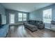Well-lit living room features a large sectional sofa, hardwood floors, and natural lighting at 1689 Eider Down Dr, Summerville, SC 29483