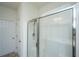 Bright bathroom featuring a glass shower with tile surround, door to closet, and tiled floor at 1689 Eider Down Dr, Summerville, SC 29483