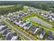 Beautiful aerial view of the community featuring manicured lawns, a pond, and a view of the sports fields at 1832 Agate Bay Dr, Mount Pleasant, SC 29466