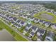 Expansive aerial shot of the neighborhood showcasing consistent architectural design and community layout with central pond at 1832 Agate Bay Dr, Mount Pleasant, SC 29466