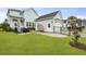 Well-maintained backyard with lush green lawn, patio seating, and privacy fencing, creating an inviting outdoor space at 1832 Agate Bay Dr, Mount Pleasant, SC 29466