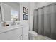 Clean, white bathroom featuring a vanity with ample storage, decorative mirror, and a shower-tub combination at 1832 Agate Bay Dr, Mount Pleasant, SC 29466