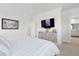 Bright bedroom featuring modern ceiling fan, TV, and access to the bathroom at 1832 Agate Bay Dr, Mount Pleasant, SC 29466