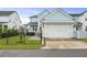 Charming home with a garage and well-manicured lawn, complemented by black fencing for added privacy and curb appeal at 1832 Agate Bay Dr, Mount Pleasant, SC 29466