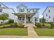 Inviting two-story home with a cozy front porch, manicured lawn, and charming curb appeal at 1832 Agate Bay Dr, Mount Pleasant, SC 29466