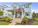 Charming light blue two-story home featuring a cozy front porch adorned with an American flag at 1832 Agate Bay Dr, Mount Pleasant, SC 29466