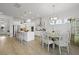 Bright, open kitchen boasts white cabinetry, stainless steel appliances, an island with seating, and seamless access to the dining area at 1832 Agate Bay Dr, Mount Pleasant, SC 29466