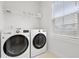 Well-lit laundry room with modern washer and dryer units, a wire shelf, and a window providing natural light at 1832 Agate Bay Dr, Mount Pleasant, SC 29466
