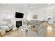 Comfortable living room features a fireplace with shiplap, a large gray sectional sofa, and plenty of natural light at 1832 Agate Bay Dr, Mount Pleasant, SC 29466