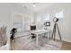 Bright home office featuring multiple windows, a large white desk, and stylish decor at 1832 Agate Bay Dr, Mount Pleasant, SC 29466