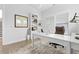 Bright office space featuring a white desk, built-in shelving, and natural light from windows, creating a serene workspace at 1832 Agate Bay Dr, Mount Pleasant, SC 29466
