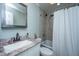 Updated bathroom with gray tiled shower and a granite-topped vanity at 1917 Piper Dr, Charleston, SC 29407