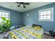 Cozy bedroom with light blue walls, natural light, and unique Peanuts themed bedding at 1917 Piper Dr, Charleston, SC 29407