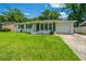 Charming home with a white brick exterior, well-manicured lawn, and a single-car garage at 1917 Piper Dr, Charleston, SC 29407