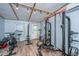 Bright home gym with pull-up bar, weight rack, and assorted machines with wood laminate flooring at 1917 Piper Dr, Charleston, SC 29407