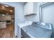 Laundry room featuring a modern washer and dryer with white cabinets above at 1917 Piper Dr, Charleston, SC 29407