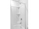 Clean white bathtub and shower combo with built-in shelves and chrome fixtures at 1928 Mossdale Dr, Johns Island, SC 29455