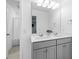 Modern bathroom featuring double sinks, gray cabinets, and a large mirror at 1928 Mossdale Dr, Johns Island, SC 29455