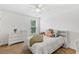 Bedroom with ceiling fan, neutral carpet, and a large window with natural light at 1928 Mossdale Dr, Johns Island, SC 29455