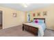 Cozy bedroom with a wooden bed frame, carpeted floors, and warm yellow walls at 1928 Mossdale Dr, Johns Island, SC 29455