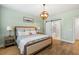 Comfortable bedroom boasts hardwood floors, natural lighting, and a barn door bathroom entrance at 1928 Mossdale Dr, Johns Island, SC 29455