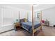 Stylish bedroom with natural light, four poster bed, and coordinated decor at 1928 Mossdale Dr, Johns Island, SC 29455