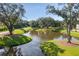 Picturesque community lake surrounded by lush greenery and manicured lawns at 1928 Mossdale Dr, Johns Island, SC 29455