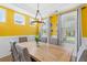 Dining area with yellow walls, lots of windows, and a wooden table with seating at 1928 Mossdale Dr, Johns Island, SC 29455