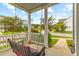Inviting covered front porch featuring a porch swing and views of the manicured landscaping at 1928 Mossdale Dr, Johns Island, SC 29455