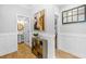 Hallway with hardwood floors and views into a bathroom and bedroom at 1928 Mossdale Dr, Johns Island, SC 29455