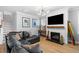Comfortable living room features a fireplace, a mounted television, and hardwood floors at 1928 Mossdale Dr, Johns Island, SC 29455
