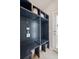 Mud room with dark blue shelving and storage units; exit door to the backyard at 1928 Mossdale Dr, Johns Island, SC 29455