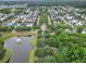 Aerial view of neighborhood featuring tree-lined streets and a pond with fountain at 205 White Gables Dr, Summerville, SC 29483