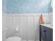A half-bath featuring blue and white patterned wallpaper and traditional wainscoting at 205 White Gables Dr, Summerville, SC 29483