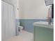 Bathroom showcasing a green vanity, updated fixtures, and bathtub with shower at 205 White Gables Dr, Summerville, SC 29483