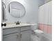Bathroom with hexagonal tile floors, modern vanity, and a round mirror at 205 White Gables Dr, Summerville, SC 29483