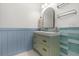 Bathroom featuring a green vanity with modern fixtures, hexagon tile flooring, and an arch mirror at 205 White Gables Dr, Summerville, SC 29483