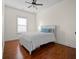 A bright bedroom with hardwood floors, a ceiling fan, and a classic white bed at 205 White Gables Dr, Summerville, SC 29483