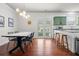 Open dining area with modern light fixture, table, and access to the patio at 205 White Gables Dr, Summerville, SC 29483