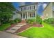 Beautiful two-story home with a front porch, landscaped yard, and a welcoming entrance at 205 White Gables Dr, Summerville, SC 29483