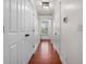 Hallway with wood floors, white walls, and paneled doors leading to other rooms at 205 White Gables Dr, Summerville, SC 29483