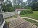 Enclosed backyard with small shed, fence, and walkway at 207 Cedar St, Saint George, SC 29477