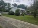 Cozy home featuring a wheelchair ramp, fence, and trees at 207 Cedar St, Saint George, SC 29477