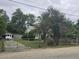 Front exterior view of a home with a chain link fence and gated driveway at 207 Cedar St, Saint George, SC 29477