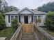 White exterior single story home featuring a wheelchair ramp at 207 Cedar St, Saint George, SC 29477