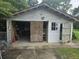 Exterior view of a garage with sliding doors and an open window at 207 Cedar St, Saint George, SC 29477