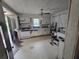 Bright kitchen area featuring appliances, cabinetry, and an exterior door at 207 Cedar St, Saint George, SC 29477